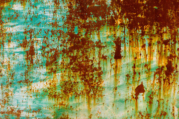 Weathered metal surface with rust and peeling paint outdoors