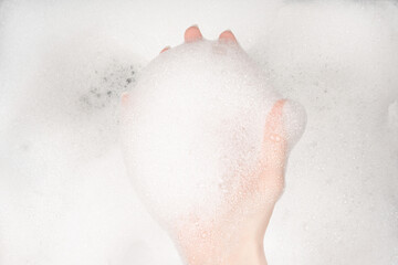 Female hands in foam close-up. girl's hands in soap foam. washing, cleaning, washing dishes