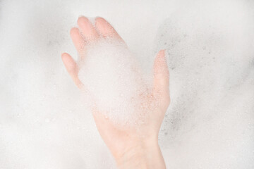 Female hands in foam close-up. girl's hands in soap foam. washing, cleaning, washing dishes