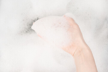 Female hands in foam close-up. girl's hands in soap foam. washing, cleaning, washing dishes