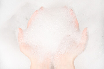 Female hands in foam close-up. girl's hands in soap foam. washing, cleaning, washing dishes