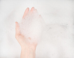 Female hands in foam close-up. girl's hands in soap foam. washing, cleaning, washing dishes