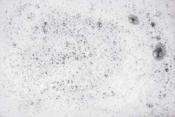 White pure foam in water background texture. dishwashing foam close up