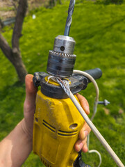 Damaged electrical wire wrapped around an old electric drill
