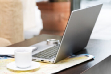 Fototapeta premium Freelancer working on education project using laptop in cozy online geography workspace. Blurred focus