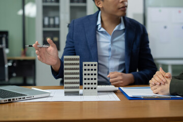 Real estate broker agent presenting and consult to customer to decision making sign insurance form...