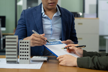 Real estate broker agent presenting and consult to customer to decision making sign insurance form...