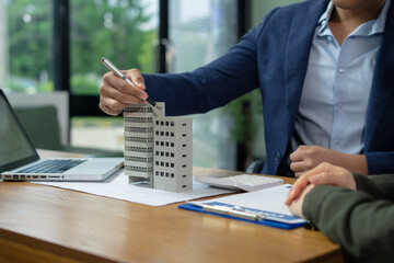 Real estate broker agent presenting and consult to customer to decision making sign insurance form...