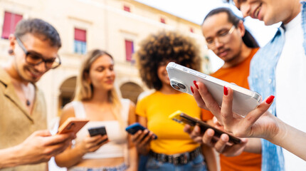 Happy young people having fun watching smart mobile phone device - Technology life style concept