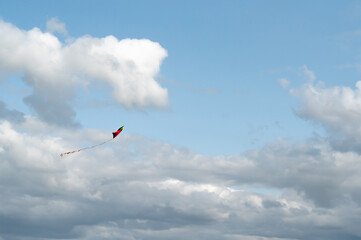 The Colorful and Vibrant Kite Flying High in a Bright and Clear Blue Sky Above Us All