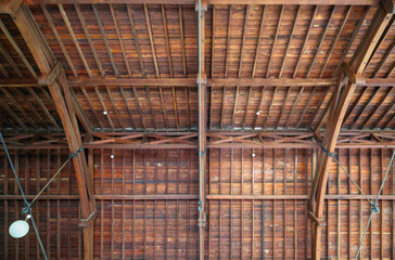 Indigenous Australian Jarrah hardwood roof beams, shingles. Beautiful, durable, strong. Natural resistance to fire, rot, and termites. Deforestation, forest fires, climate change threats. Background