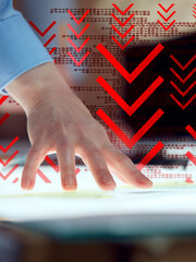 Outstretched hand highlights dramatic red arrows and binary code suggesting financial or digital...