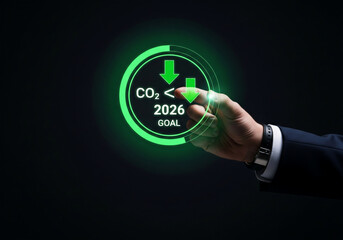 hand touches a glowing digital screen showing a 2026 co2 reduction goal