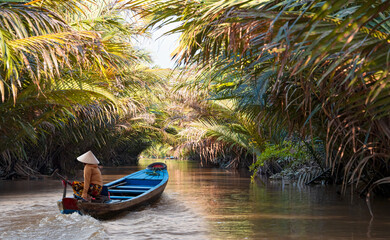 Fisherwoman is fishing in Mekong river in the morning - People boating in the delta of Mekong...