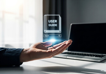 a hand hovers over a digital user guide icon above a laptop