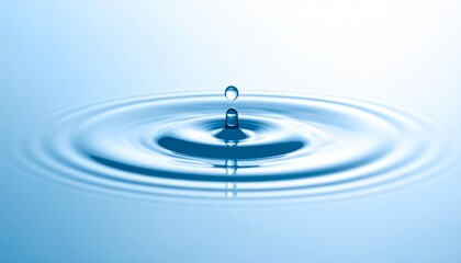 A blue water drop creates a clean, circular ripple as it splashes, a clear reflection of purity and nature's liquid motion