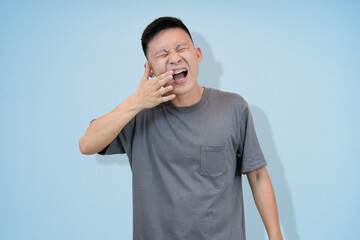 young asian man wearing braces having a teeth problem