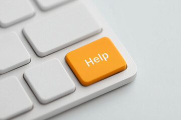 Orange help button on keyboard representing assistance, support, and troubleshooting, symbolic aid for queries, computing guidance, and user comfort