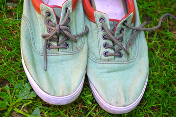 used  canvas sneakers on grass, summer footwear