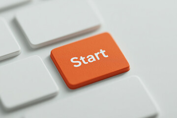 Orange start button on keyboard symbolizing power, initiation, and system boot—keycap closeup representing launch, activation, and interactive computing control