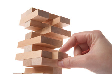 Lviv, Ukraine - December 05, 2023: Woman playing Jenga on white background, closeup