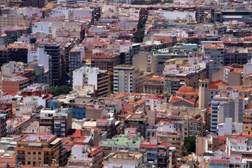 Obraz premium Alicante City Center Aerial View with Colorful Rooftops, Apartments, and Historic Church Dome in Dense Urban Fabric on a Sunny Day