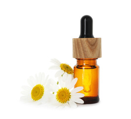 Bottle of essential oil and chamomile flowers isolated on white
