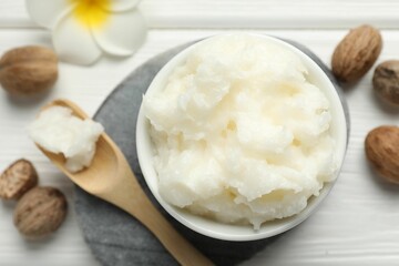 Natural shea butter on white wooden table, flat lay