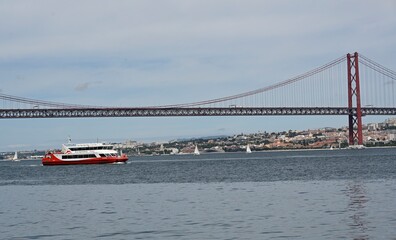 a ship in the tagus river  under the bridge at Lisbon in Portugal