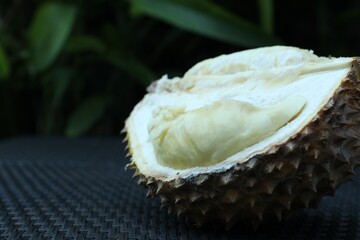 Fresh ripe durian on wicker table outdoors, closeup. Space for text