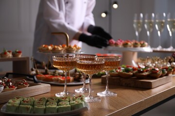 Chef arranging appetizers on buffet table, selective focus