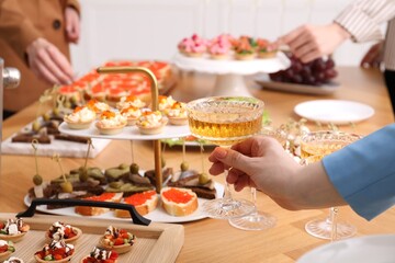 People with different appetizers at buffet, selective focus