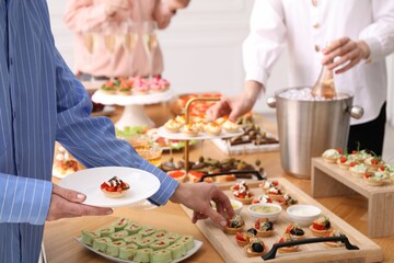 People with different appetizers at buffet, closeup