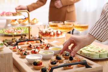 People with different appetizers at buffet, selective focus