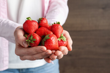 Woman with delicious ripe strawberries indoors, closeup. Space for text