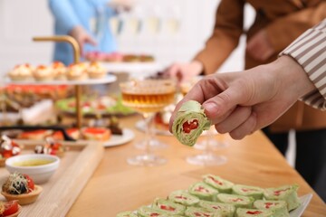 People with different appetizers at buffet, selective focus