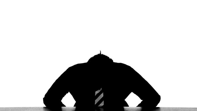 Silhouette of a male business person apologizing