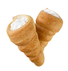 Two horns of puff pastry with cream fly close-up on a white. Isolated