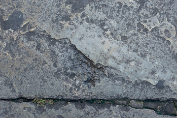 Close-up of a street floor with cracks in the shape of a line. Texture, background for work. abstract