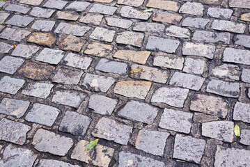 Texture of a street pavement with square and rectangular stones. Geometric pattern. Background. Abstract. Copy space.