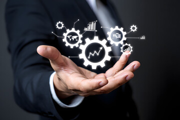 Businessman s open hand presenting a digital network of gears with global business and financial data charts