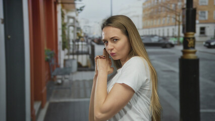 Fototapeta premium Woman gesturing a finger pistol on a city street outdoors expressing playfulness and confidence.