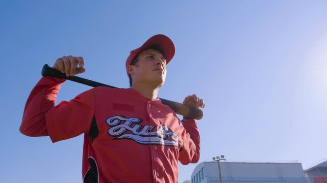 A Young and Enthusiastic Baseball Player Preparing for Action on the Field in Bright Sunshine