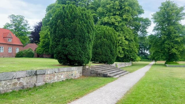 Viborg, Denmark - June 22, 2025: View over Hald Lake from Dollerup bakker. Tree row avenue at Hald lake. Heather lands. The Manor House of Hald in Dollerup, location of this historical building.