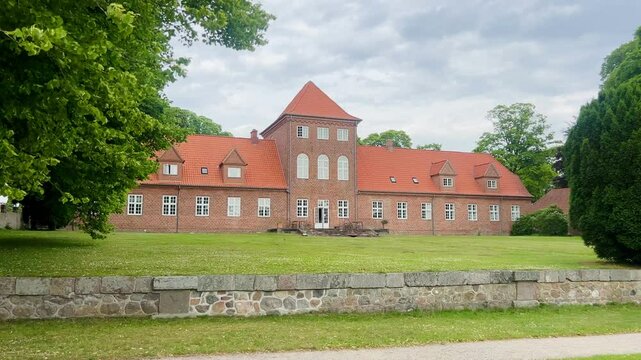 Viborg, Denmark - June 22, 2025: View over Hald Lake from Dollerup bakker. Tree row avenue at Hald lake. Heather lands. The Manor House of Hald in Dollerup, location of this historical building.