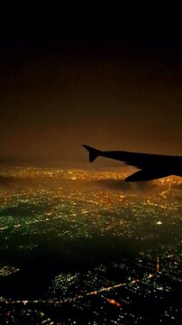 Night flight in Indonesia from Soekarno Hatta airport, Jakarta to Kualanamu, Medan. Dark mode with light points on buildings, street lights, transportation and various lights from the ground. 