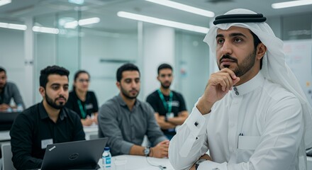 Thoughtful Emirati businessman contemplates during a modern office seminar.