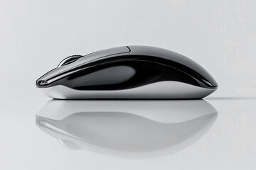 Wireless computer mouse on reflective desk surface