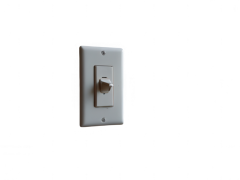Close up of a dimmer switch on a white plate against a black background