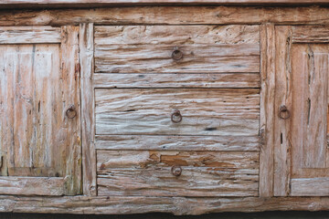 A close-up of a wooden surface severely damaged by termites, showcasing splintered, hollow, and...